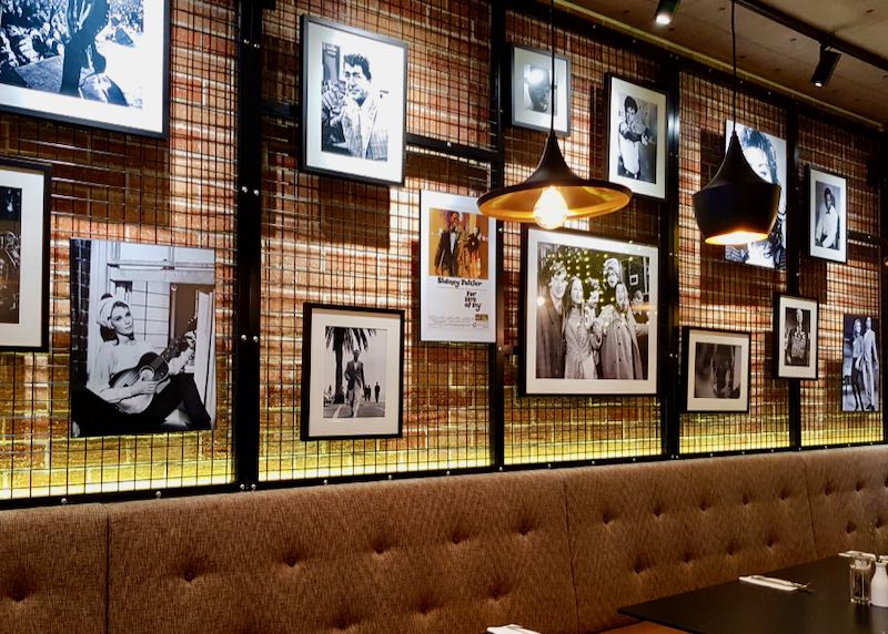 Photos of old movie stars adorn the wall.