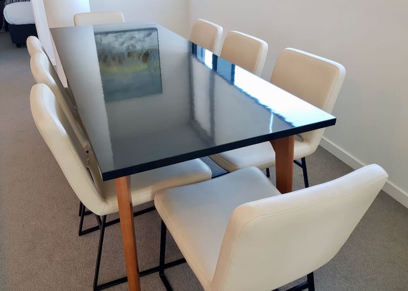 Large apartments have big dining tables.