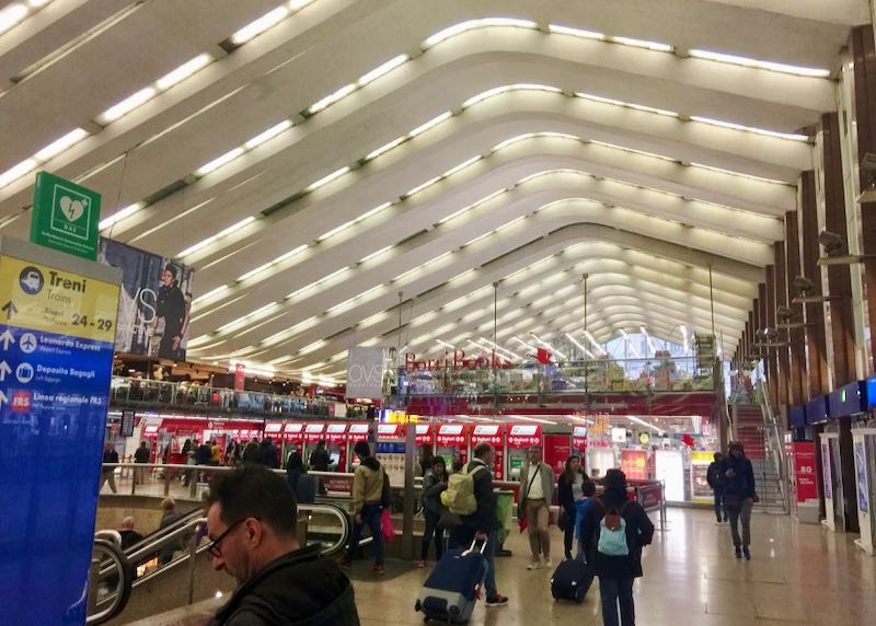 Travelers in the main ticketing area of Roma Termini train station