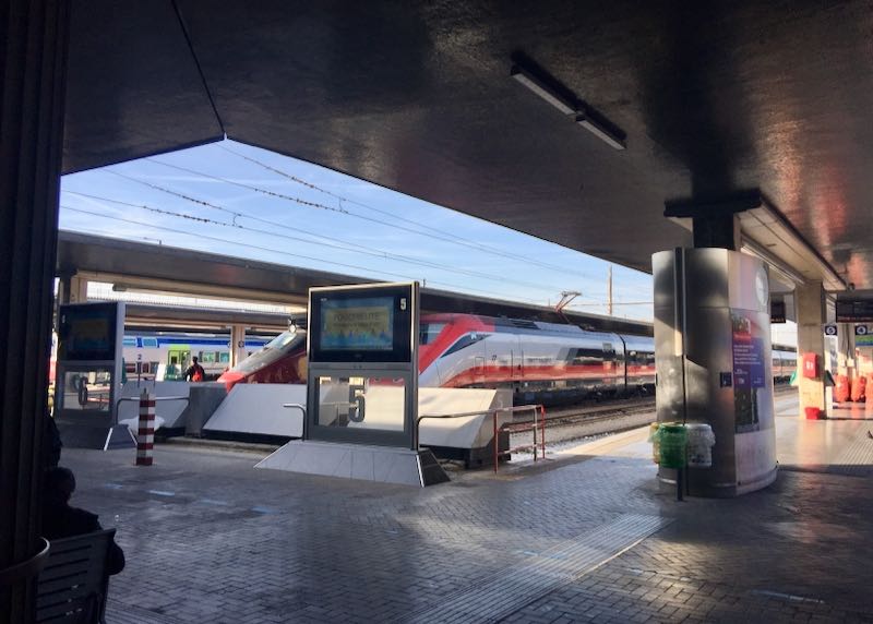 Train platform with waiting train at Santa Lucia railway station in Milan