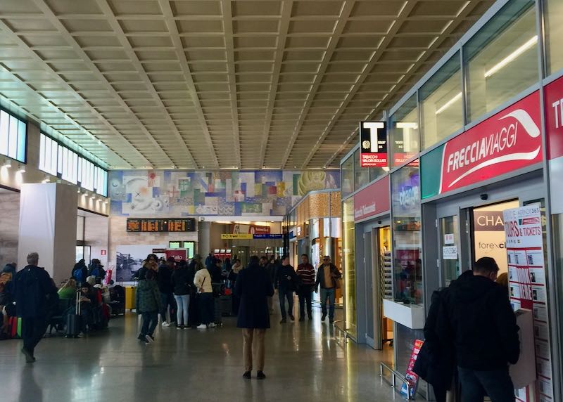 Travelers in the central terminal of the Venice train station