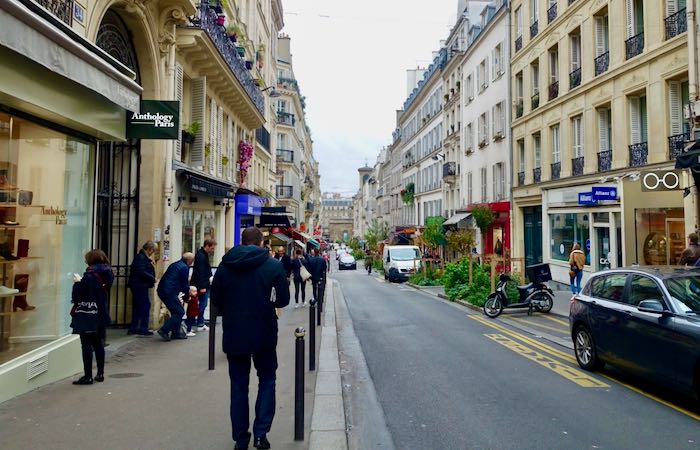 Pedestrians walk and shop on the Rue des Martyrs in Paris