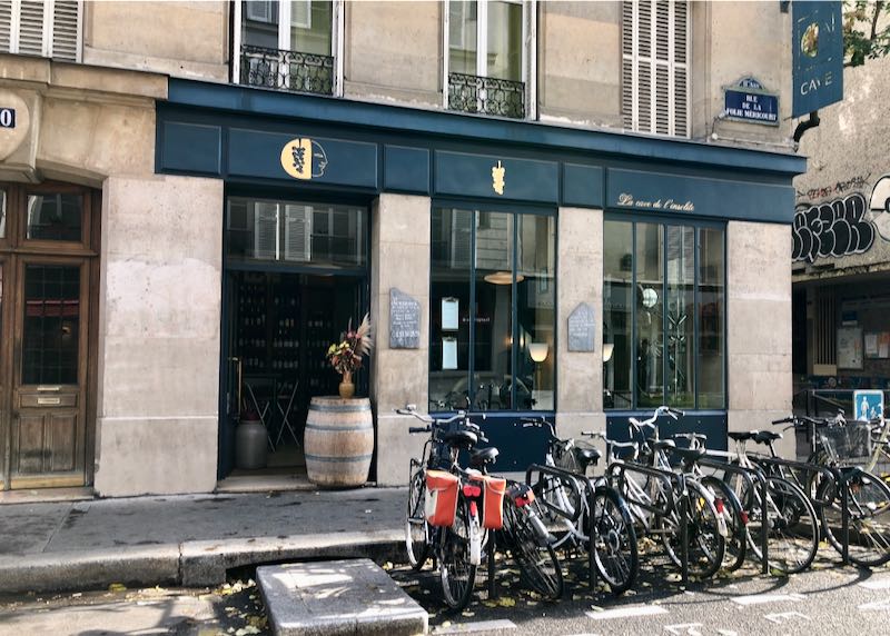 Exterior of a wine bar in paris with bikes parked in front