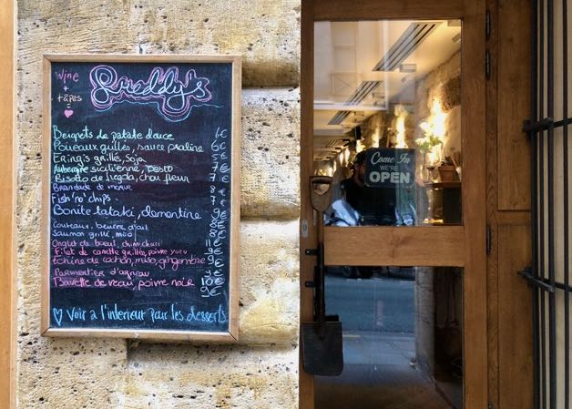 Chalkboard menu of a French restaurant, posted next to the door 