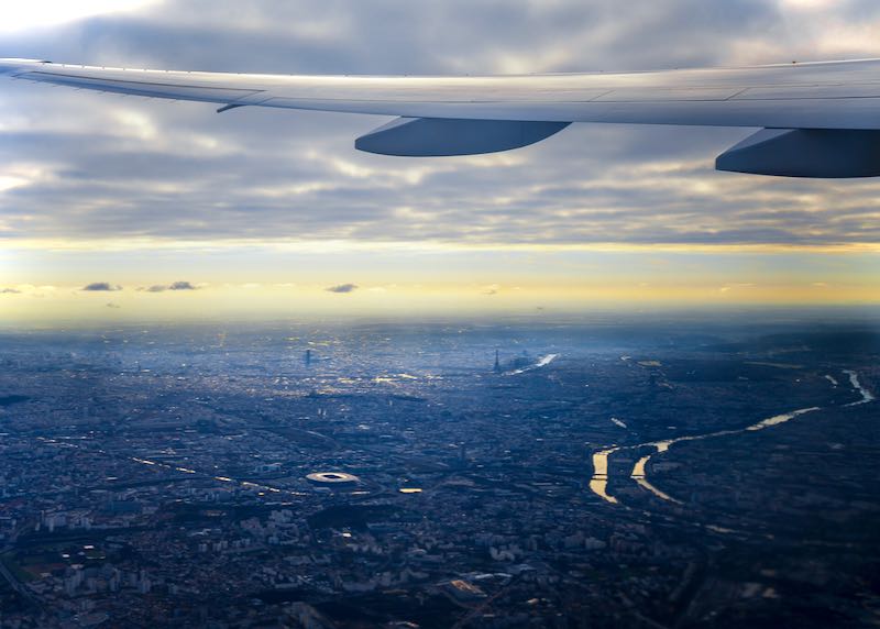 View of Paris from an airplane window at dusk