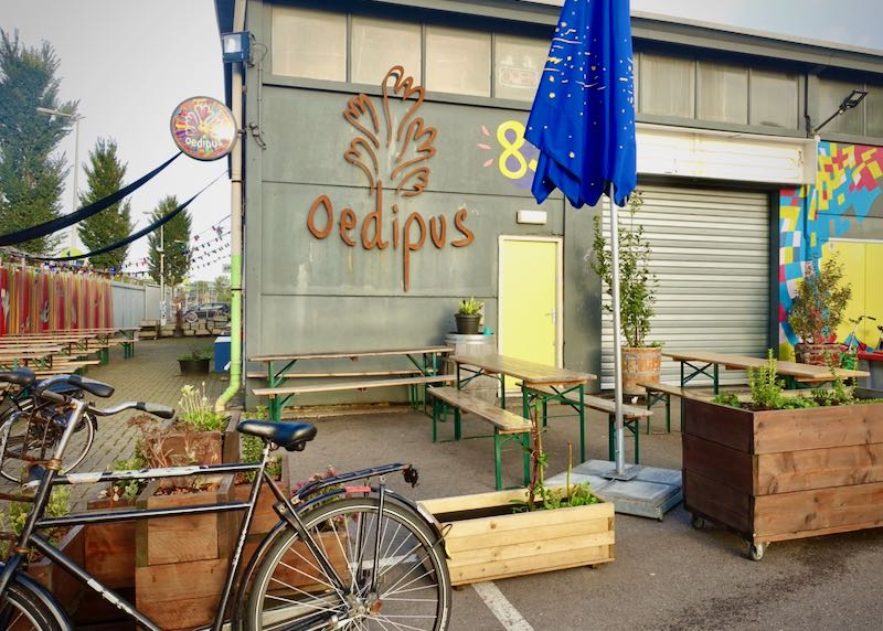 Exterior of a brewery with picnic tables and bikes in front