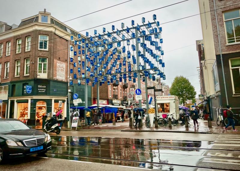 Entrance to an outdoor food market, hung with blue decorations