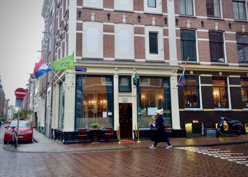 Exterior of a corner restaurant on an Amsterdam street on a rainy day
