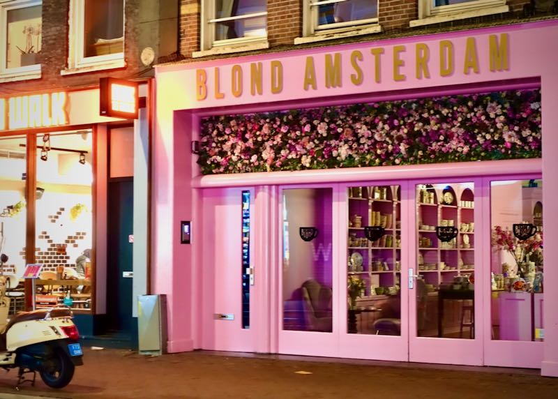 Bright pink storefront covered in fake flowers