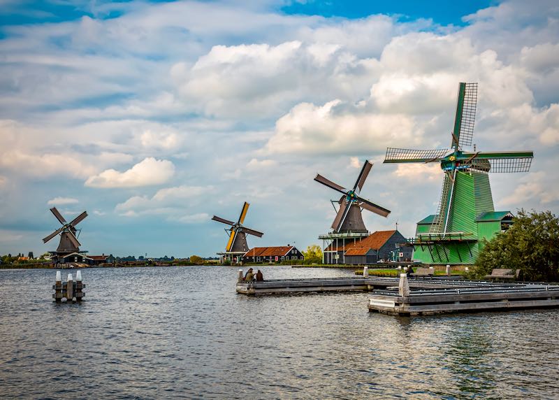 Colorful Zaanse Schans windmills, perched on the edge of the water