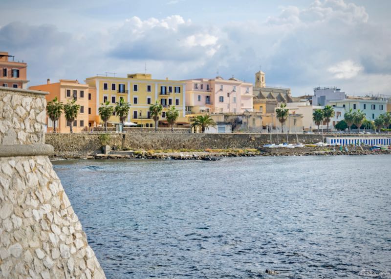 A view of Civitavecchia, also known as "Port of Rome", showing the Pirgo beach and the coastal street Thaon De Revel with its residential buildings, Church of the Holy Japanese Martyrs and the small harbor of Lega Navale.