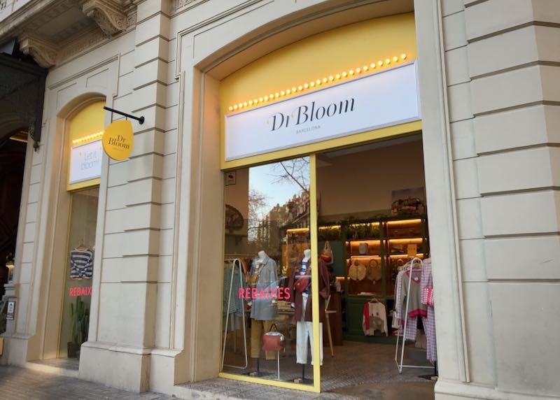 Exterior of a clothing shop with a bright yellow awning