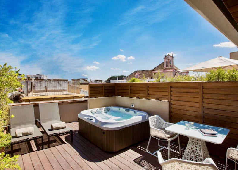 The suite has a private terrace with a jacuzzi.