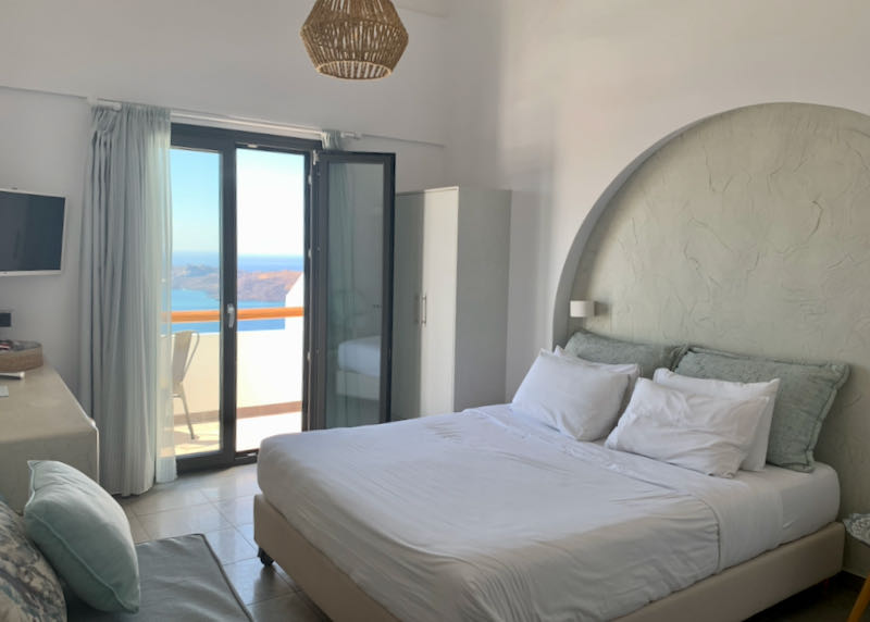 King sized bed next to a private, sea-view balcony