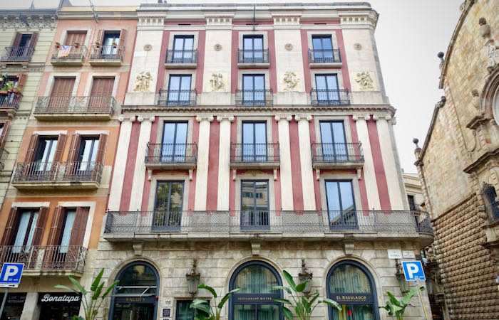 Exterior of a four-story apartment building in Barcelona