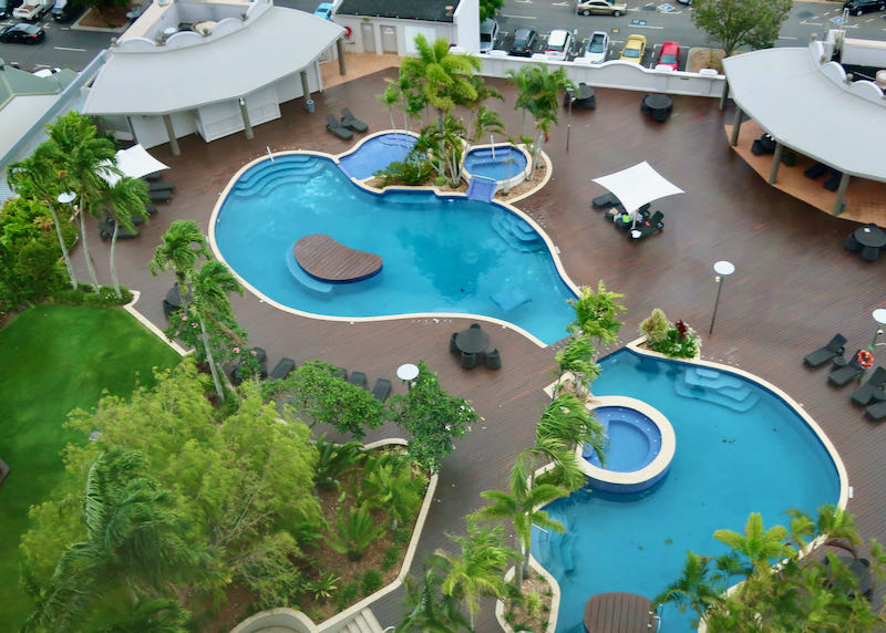 The large pool has a wooden deck.