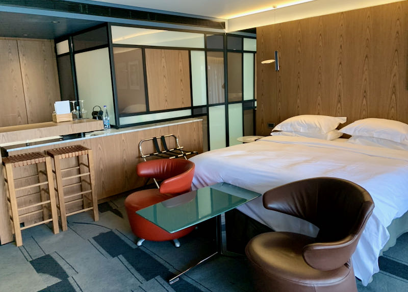 Hotel room with modern leather chairs and a minibar