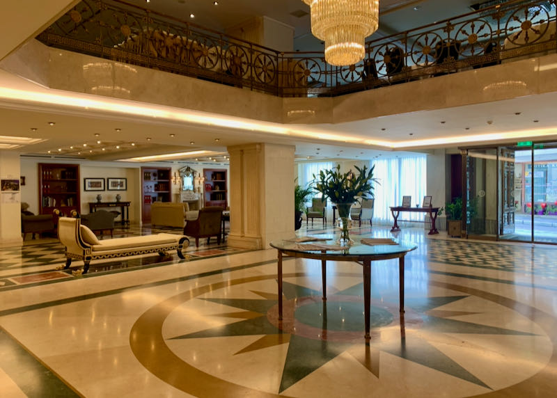 Hotel lobby with marble flooring and a chandelier