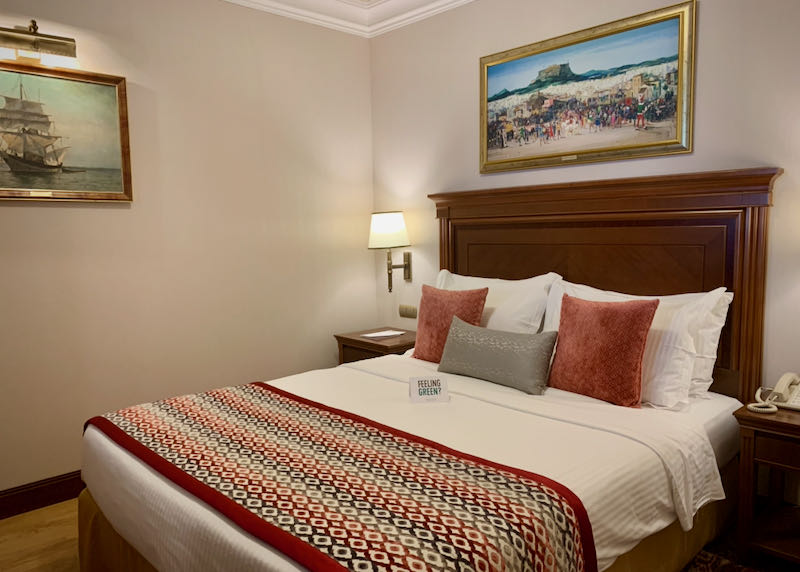 Hotel bed with framed artwork