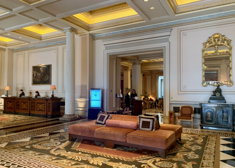 Ornate hotel lobby with agents behind desks