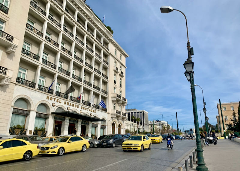 Exterior of Hotel Grande Bretagne in Athens, with taxis out front.