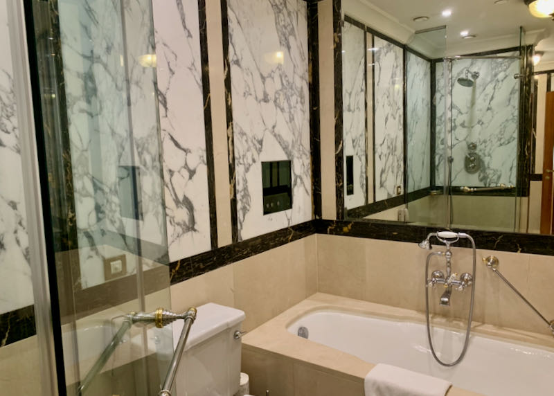 Marble bathtub in a hotel bathroom.