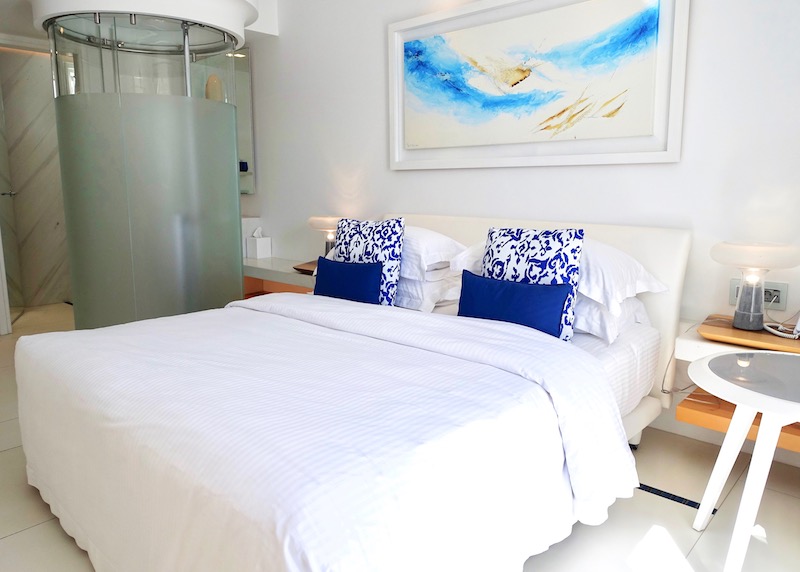 True Blue Room bed and shower at Myconian Ambassador in Platis Gialos