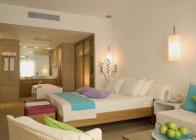 A bedroom in a Diamond Suite at Petasos Beach Resort and Spa in Mykonos