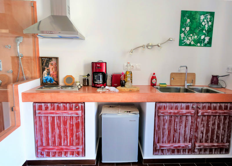 Small kitchen with stovetop, wink, and refrigerator
