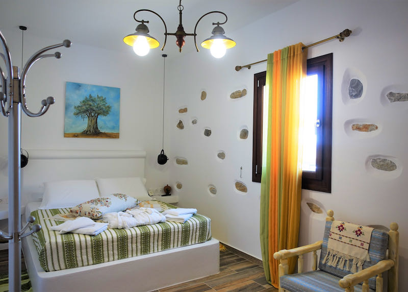 Hotel room with Greek art and stones embedded in the wall