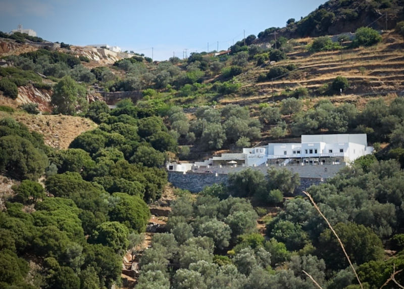 White, Cycladic style hotel set on a mountain