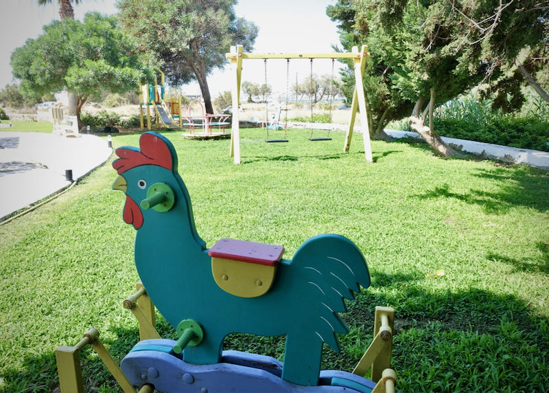 Children's playground with swingset and ride-on toys 