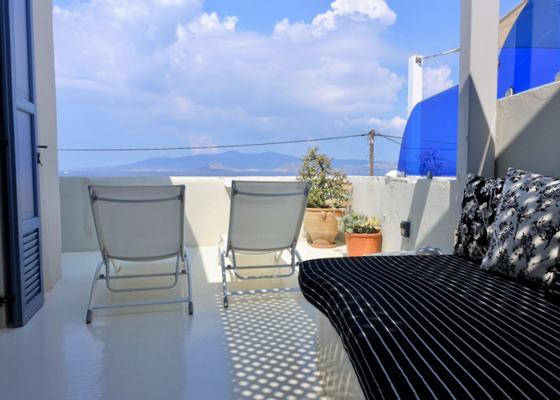Sun lounge chairs on a sea-facing balcony