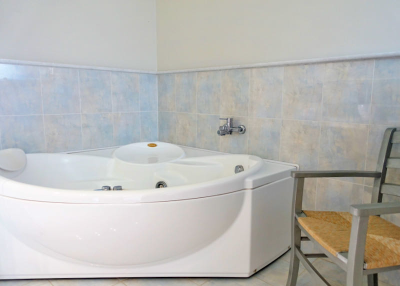 White Jacuzzi bathtub in a hotel bathroom.