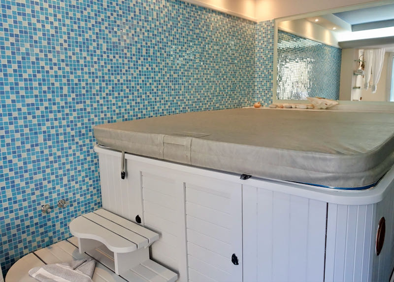 Covered hot tub with tiled walls