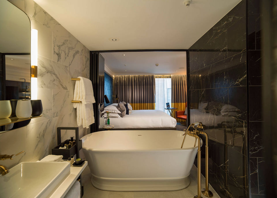 Hotel room with freestanding rolltop bathtub