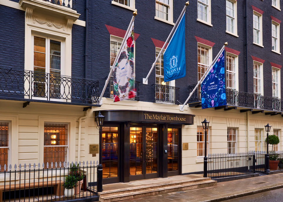 Exterior of a London hotel, with three flags flying in front
