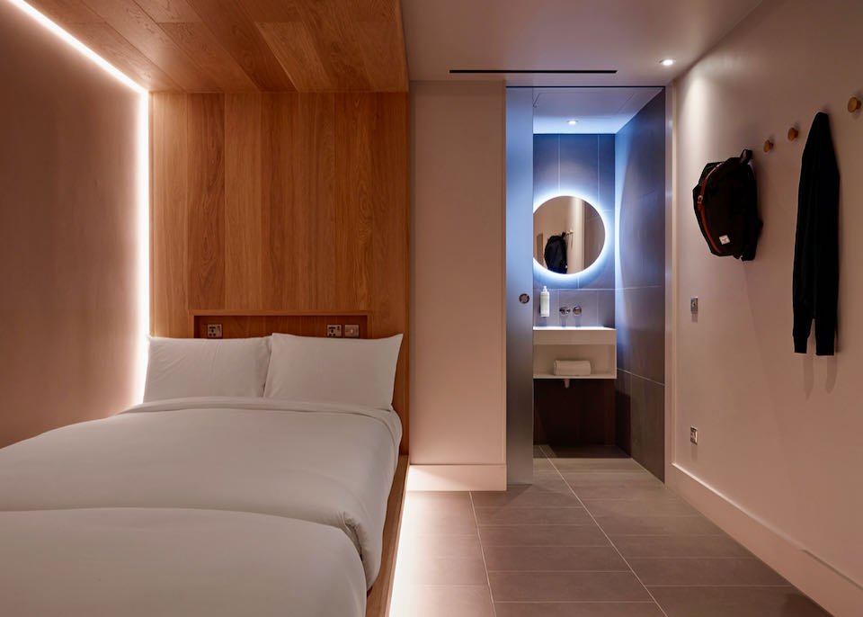 sleek hotel room with wood details and minimalist furnishings