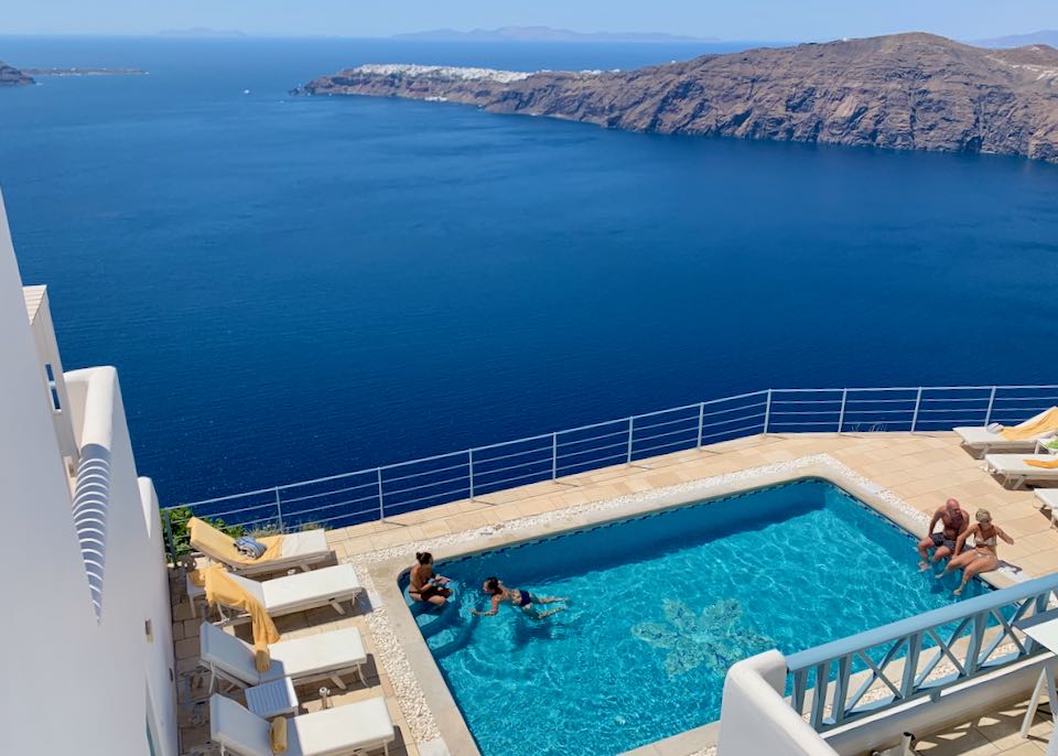 Swimming and hot sunny weather in Santorini.