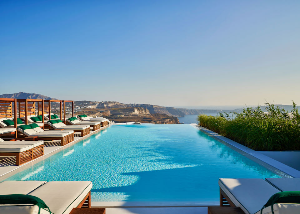 Blue infinity pool overlooking the Santorini Caldera