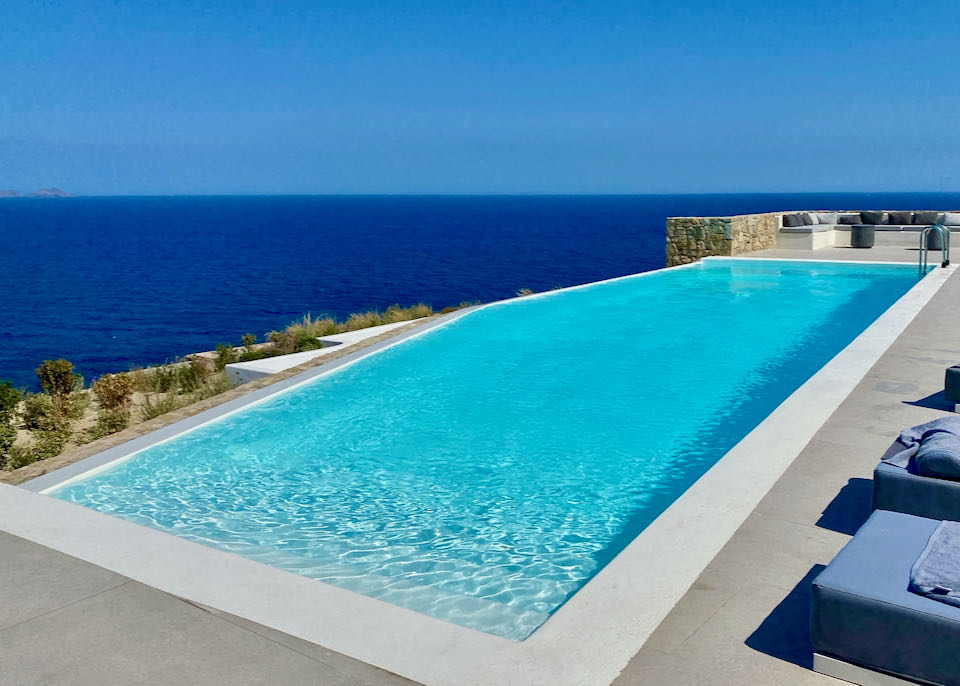 Sparkling blue infinity pool looking out over the blue sea