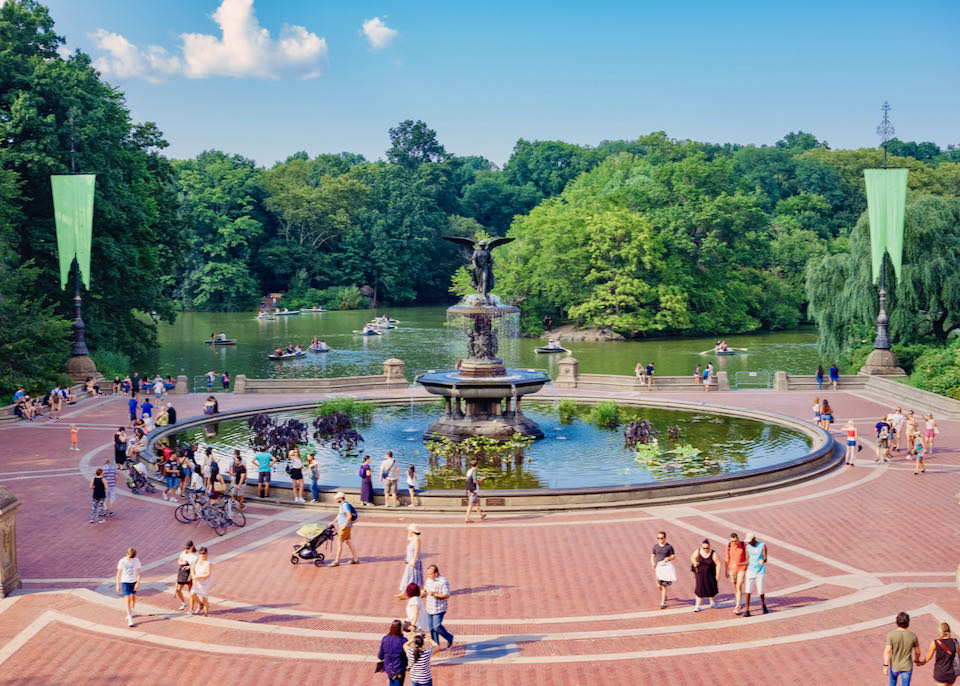 New Yorkers relaxing around Bethesda Fountain in Central Park on a sunny summer day