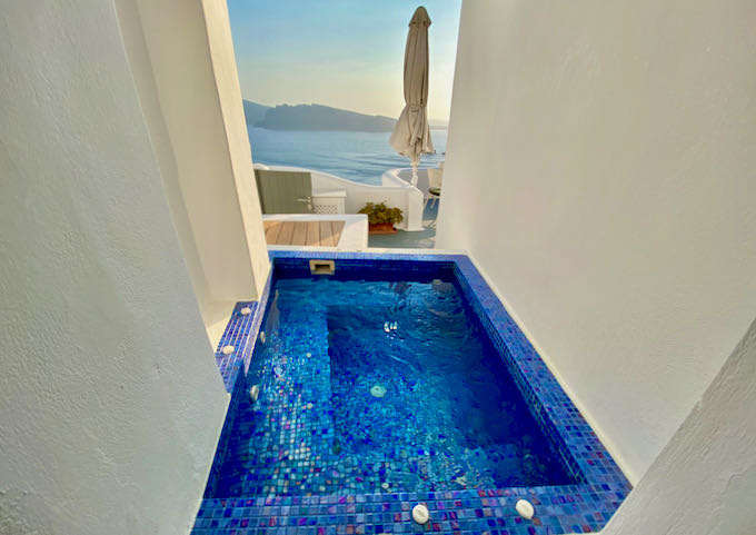 Indoor/outdoor blue-tiled jacuzzi with sea views