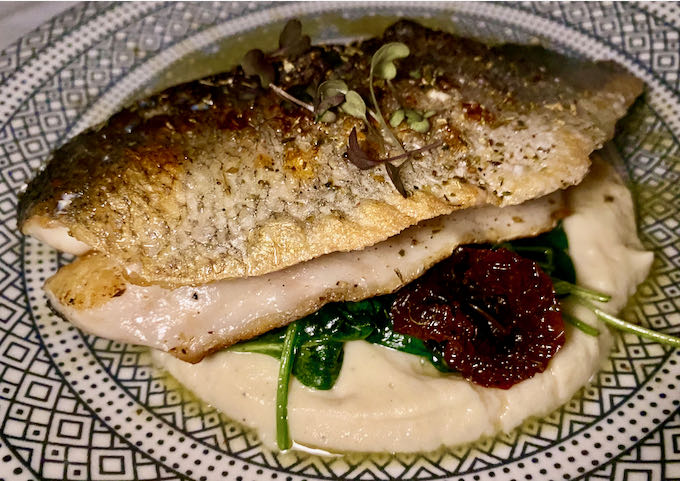 Freshly-caught fish of the day with boiled leafy greens, sun-dried tomatoes, and celery purée.