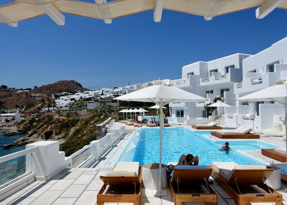 Nissaki Boutique Hotel pool and view to Psarou Beach in Mykonos.