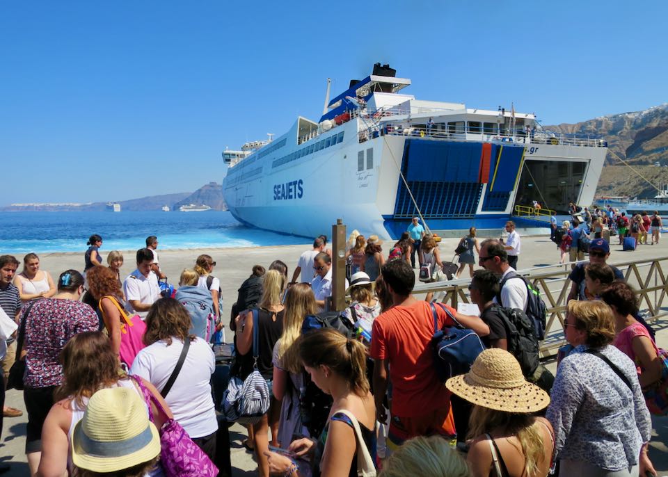 Passengers boarding a ferry at the Santorini port of Athinios.