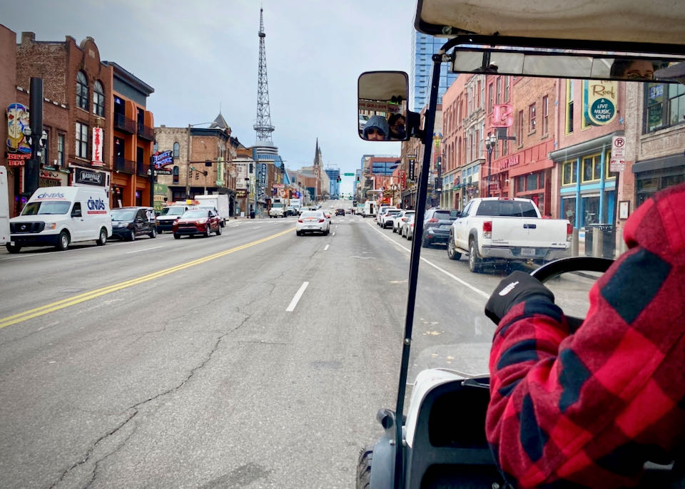 View of Nashville's main drag, full of bars and music venues, from the back of a golf cart