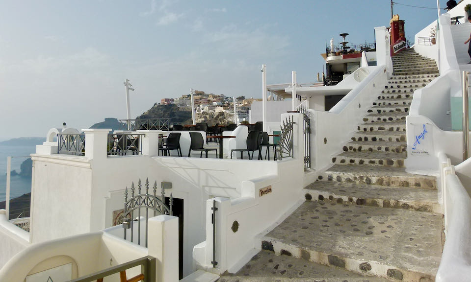 Steep stone staircase on a Fira cliffside.
