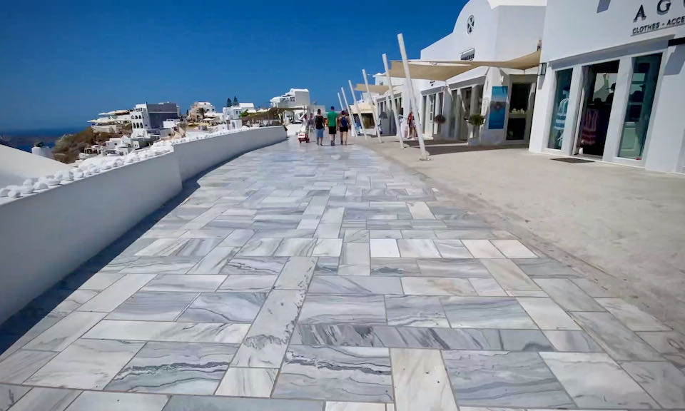 Wide paved marble path lined with shops