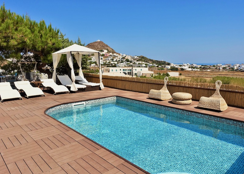 Pool and sunbeds at Eiriana Luxury Suites in Milos